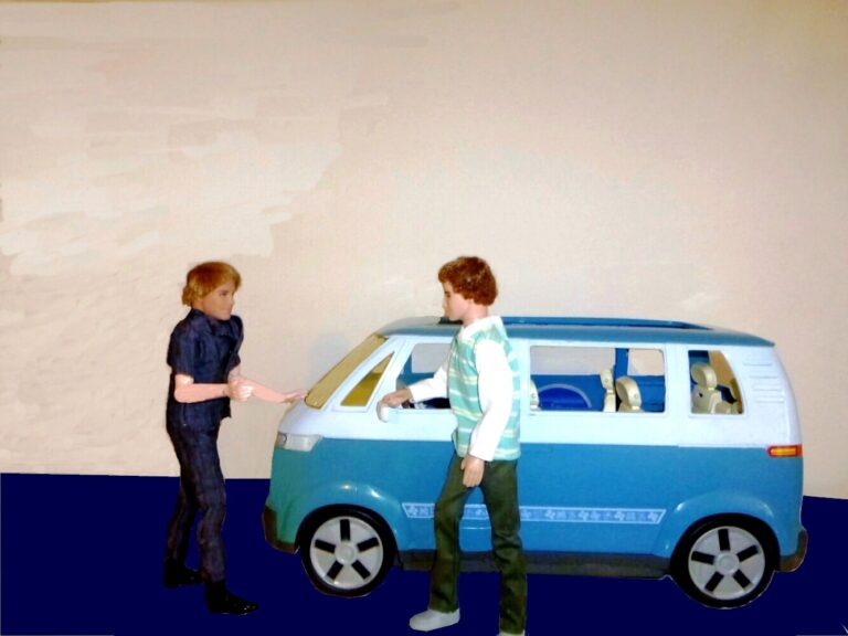 2 male dolls standing with a blue VW style tour bus