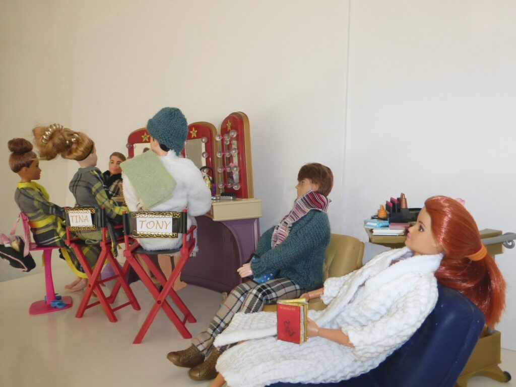 Group of dolls sitting in a dressing room